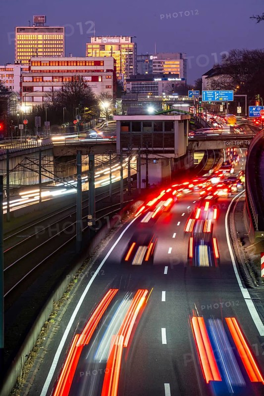 Motorway A40, Ruhr expressway, heavy traffic jam, rush hour, city passage in Essen, skyline of the city centre, underground line between the lanes, Hobeisenbrücke stop, North Rhine-Westphalia, Germany