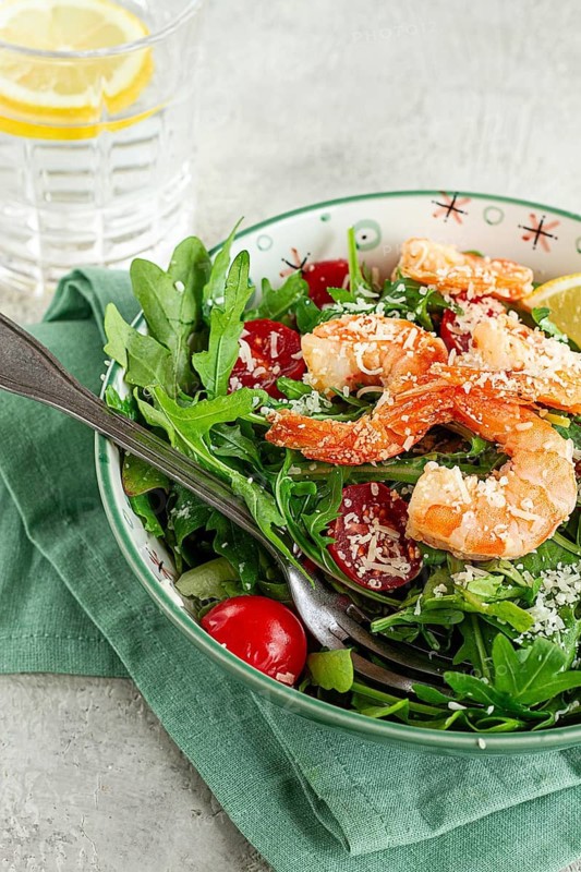 Shrimp salad with arugula and cherry tomatoes, with parmesan cheese, healthy food