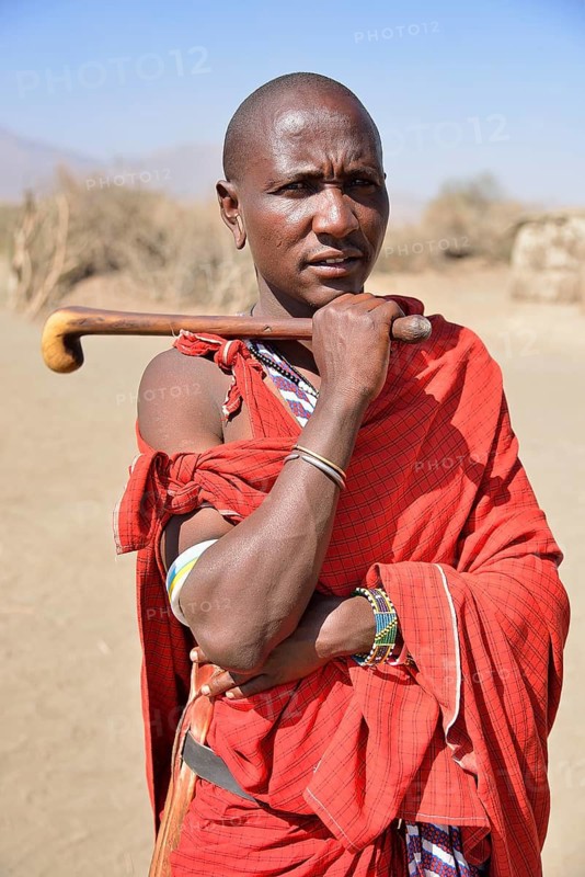 Maasai man holding a traditional shepherd's stick, Ngorongoro Conservation Area, Ndema, Tanzania