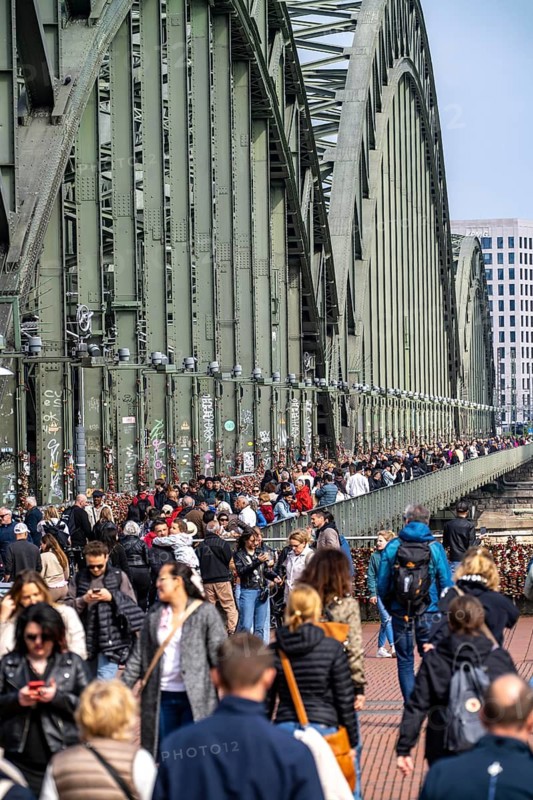 The Hohenzollern Bridge, railway bridge over the Rhine near Cologne, multi-track Rhine bridge to, from Cologne Central Station, tourists, people on the cycle and footpath, North Rhine-Westphalia, Germany