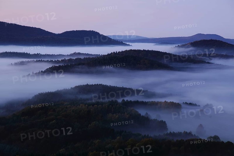 Landscape with mountains and clouds of fog in front of sunrise, nature photography, blue hour, night view, fog landscape, Wegelnburg, Dahner Felsenland, Rhineland-Palatinate, Germany