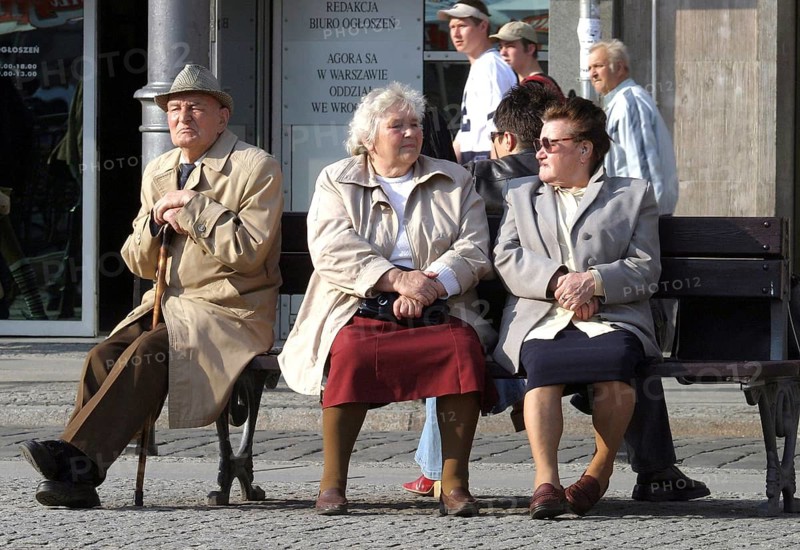 Breslau, POL, 30.04.2004 - An old man and two elderly woman sit on a bench in Wroclaw, Poland