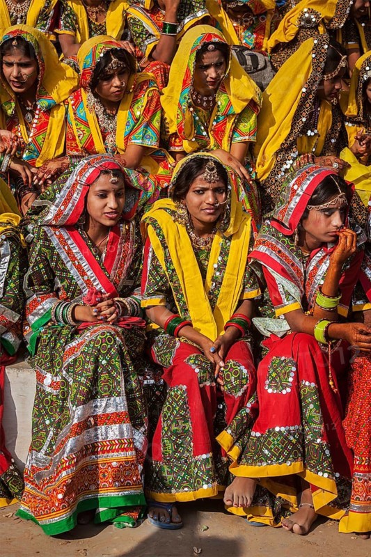 PUSHKAR, INDIA, NOVEMBER 21, 2012: Unidentified Rajasthani girls in traditional outfits prepare for dance perfomance at annual camel fair Pushkar Mela in Pushkar, Rajasthan, India