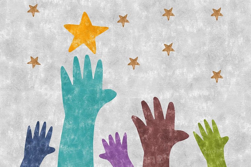 An illustration of colorful hands reaching towards gold stars against a textured background, symbolizing aspiration, unity, and the collective human spirit striving for dreams