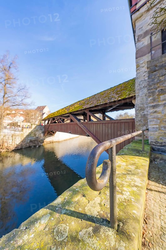 Side view of a moss-covered wooden bridge over a river, Schwäbisch Hall, Germany