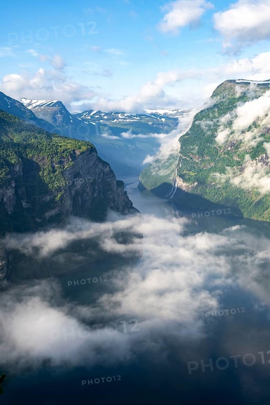 View over the Geirangerfjord, atmospheric clouds over the fjord in the morning light, Ørnesvingen viewpoint, near Geiranger, Møre og Romsdal, Norway