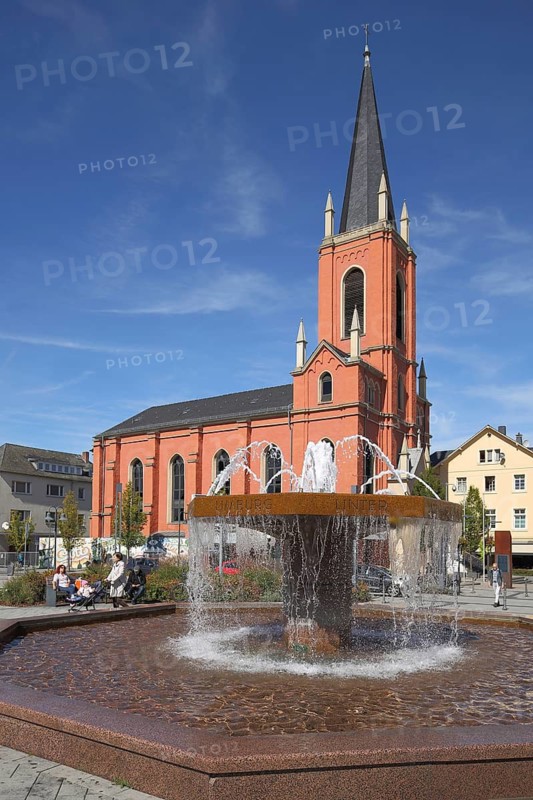 Fountain on train station square with Lutheran church in Limburg, Hesse, Germany