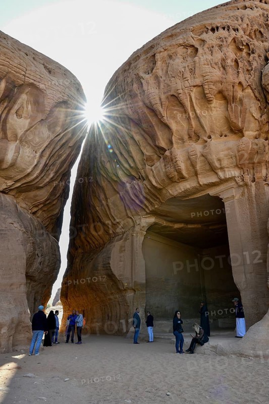 Tourists in front of the divan, Nabataean cult site carved into the rock at Jabal Ithlib, Hegra or Mada'in Salih, AlUla region, Medina province, Saudi Arabia, Arabian Peninsula