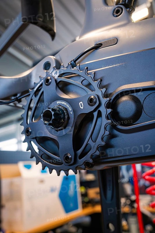 Black chainring on a bicycle frame in a well-lit workshop, Waldbike Manufaktur, bicycle workshop, Calw, district of Calw, Black Forest, Germany