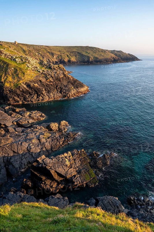 Coastal landscape at Botallack Mine, also known as Crown Mine. The ruins of Wheal Edward in the background. Evening, golden hour. Botallack, Penzance, Cornwall, England, Great Britain