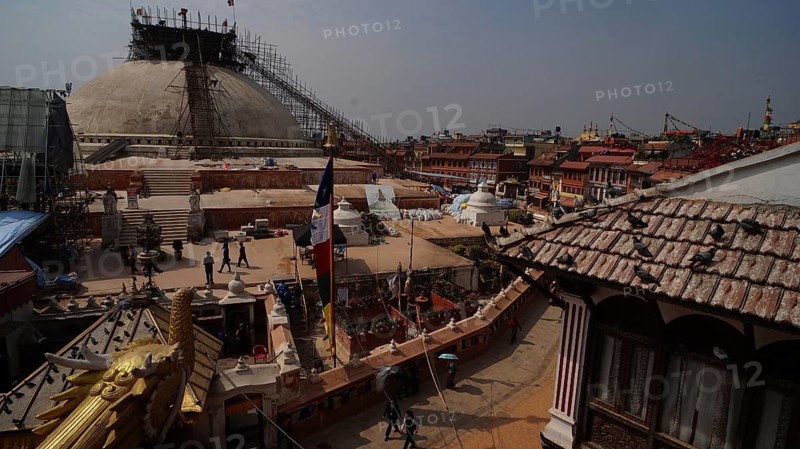 Bodnath stupa under reconstruction after the earthquake, with a view of roofs, Kathmandu, Nepal