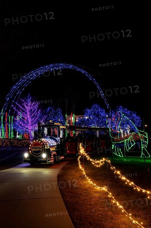 Visitors ride a train through the Christmas lights at the annual Harbor Lights Winter Festival in Gulfport, Mississippi