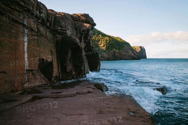 The stunning natural beauty of Flatrock in Newfoundland & Labrador, Canada, showing the dramatic cliffs and the powerful waves of the Atlantic Ocean