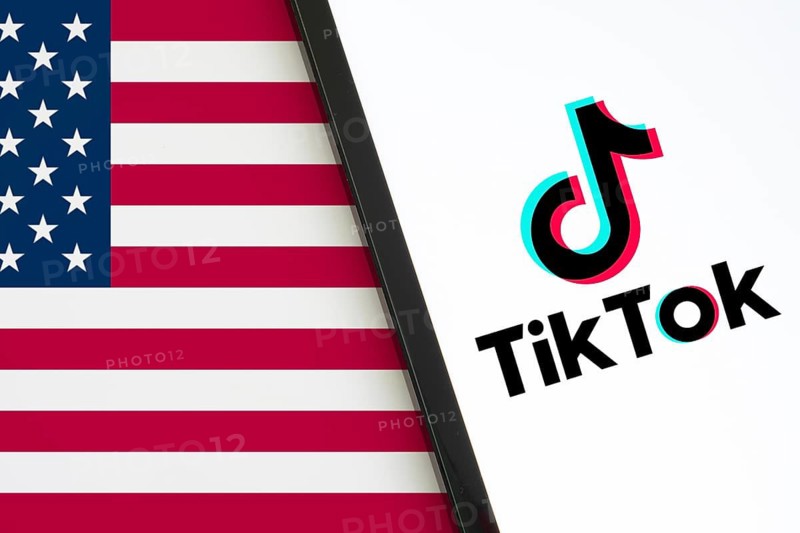 TikTok is preparing for a shutdown in the US. Tiktok logo is displayed on Ipad and USA flag in the background