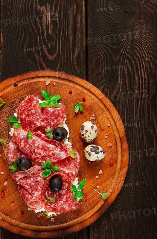 Sandwich, grain bread, with cream cheese and salami, black olives, micro-greens, top view, close-up, no people, Breakfast
