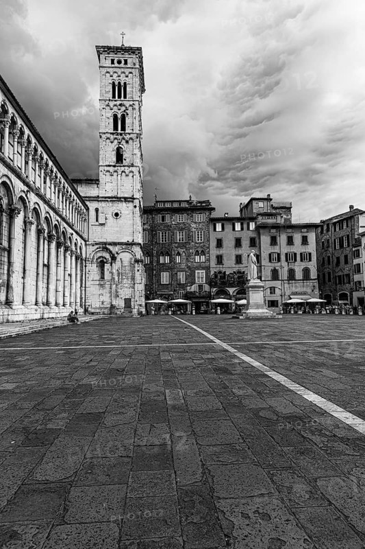 Dark rain clouds over the bell tower of the church of San Michele in Foro, historic city centre, black and white photo, Lucca, Tuscany, Italy