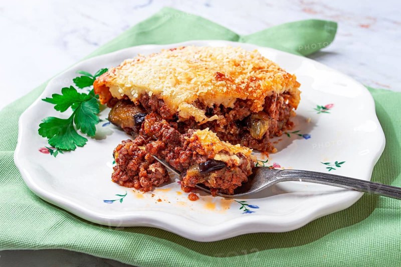 Sliced moussaka, Greek dish, baked eggplant with minced meat, with bechamel sauce, home cooking