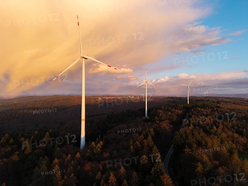 Wind turbines in the forest at dusk, with eye-catching cloud formations in the sky, near Schorndorf-Winterbach, Baden-Württemberg, Germany