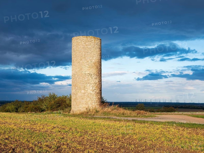 The Hakeborner Warte in a field in autumn, medieval watchtower in the Magdeburger Börde, blue sky with dramatic clouds, Hakeborn, Börde-Hakel, Saxony-Anhalt, Germany