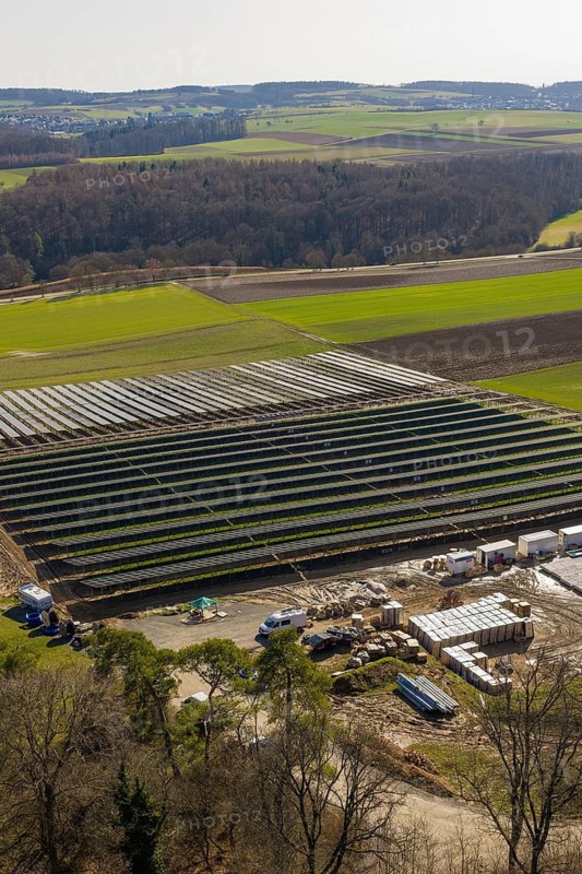 Large solar system in a field surrounded by green countryside and forests, Agri PV Bau für Landwirtschaft, Enzkreis, Germany