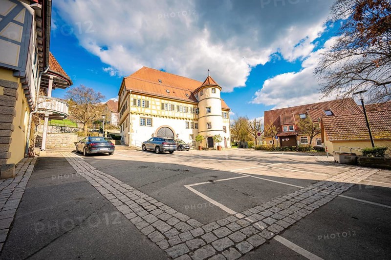 Homestead with paved courtyard and parked cars, blue sky with clouds in the background, Deufringen, Aidlingen, Böblingen district, Germany