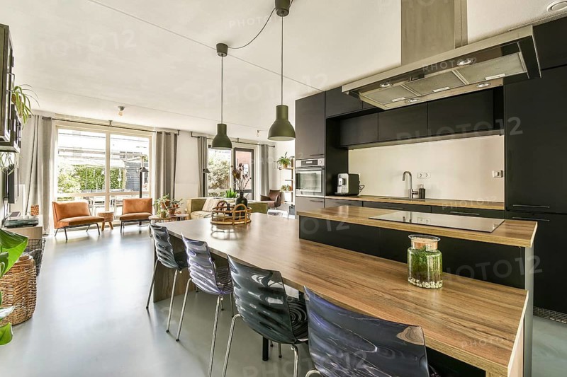 Stylish modern kitchen featuring sleek cabinetry, open space, and ample natural light. Perfect blend of functionality and aesthetics, ideal for cooking and entertaining
