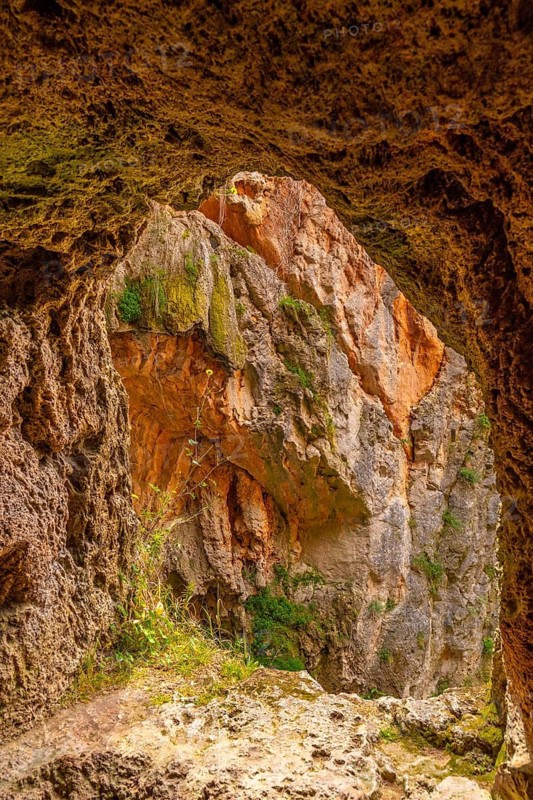 Natural window inside the Iris Grotto at the Cola de Caballo Waterfall in the Monasterio de Piedra Natural Park, Aragon