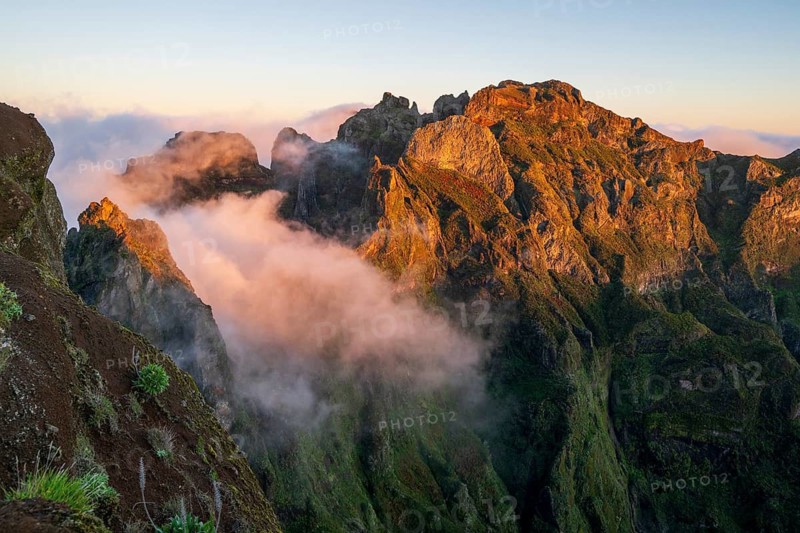 Sunrise at Pico do Arieiro, clouds of fog pass over mountain peaks, hiking trail PR1, Madeira, Portugal