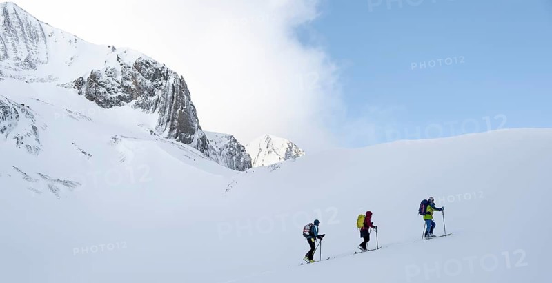Ski tourer, Snowy mountain landscape, Bernese Alps, Bernese Oberland, Switzerland