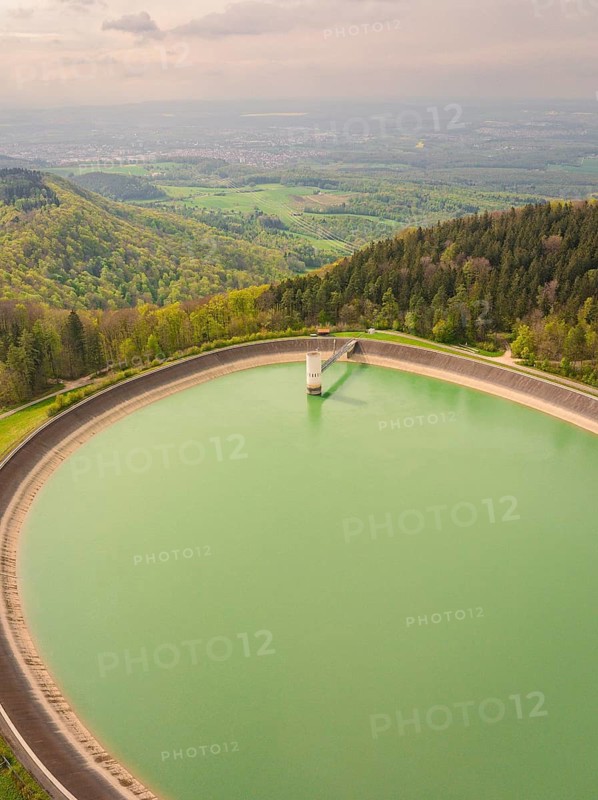 Upper reservoir, large water reservoir in a hilly landscape surrounded by dense forests, Glems reservoir, Swabian Alb, Germany