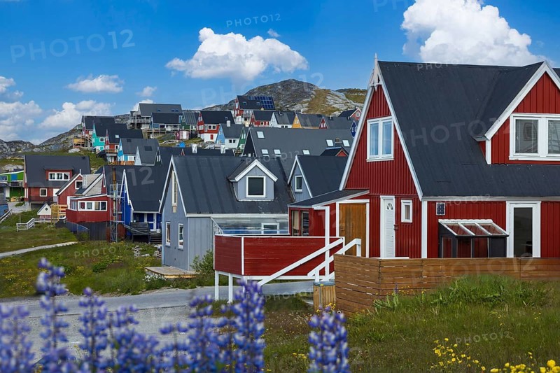 Typical architecture of Greenland capital Nuuk with colored houses located near fjords and icebergs