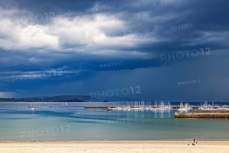 Boats in the harbor with dark thunderclouds in the sky over the sea, Crozon peninsula, Morgat, Bretagne, France