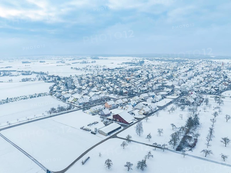Landscape with snow-covered village and neighbouring agricultural land, Deckenpfronn, Böblingen district, Germany