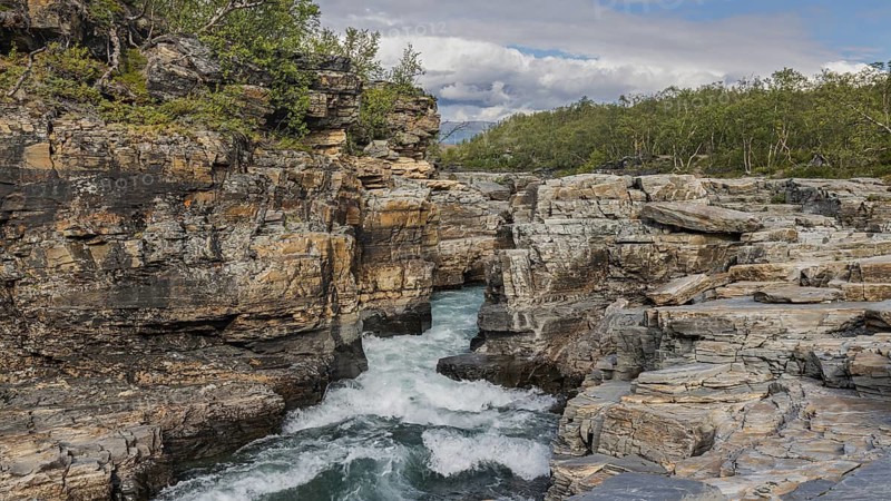 Abiskojåkka, river in Abisko NP (northern Sweden) . Rock gorge, canyon, white water, forest, clouds, roaring