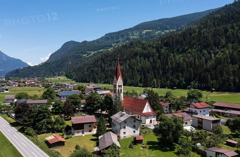 Drone shot, view of village with parish church, Schönwies, Oberinntal, Tyrol, Austria
