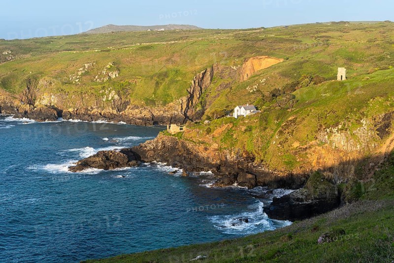 Landscape. On the headland of Gurnard's Head, view along the coast to Treen Cove with a house and Rose-an Hale Cove. The ruins of an old mine on the right. Good weather, blue sky. Gurnard's Head, Cornwall, England, Great Britain