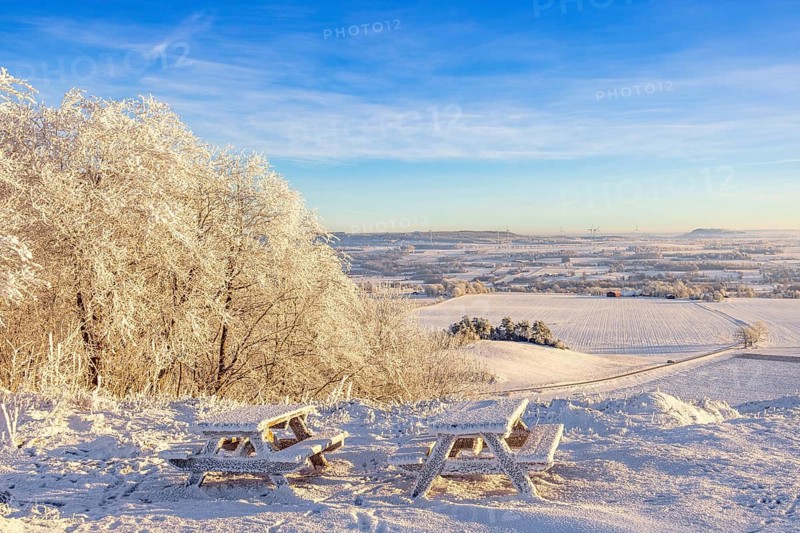 Rest area with benches and tables at a beautiful view on a hill in a frosty and snowy winter in the countryside, Ålleberg, Falköping, Sweden