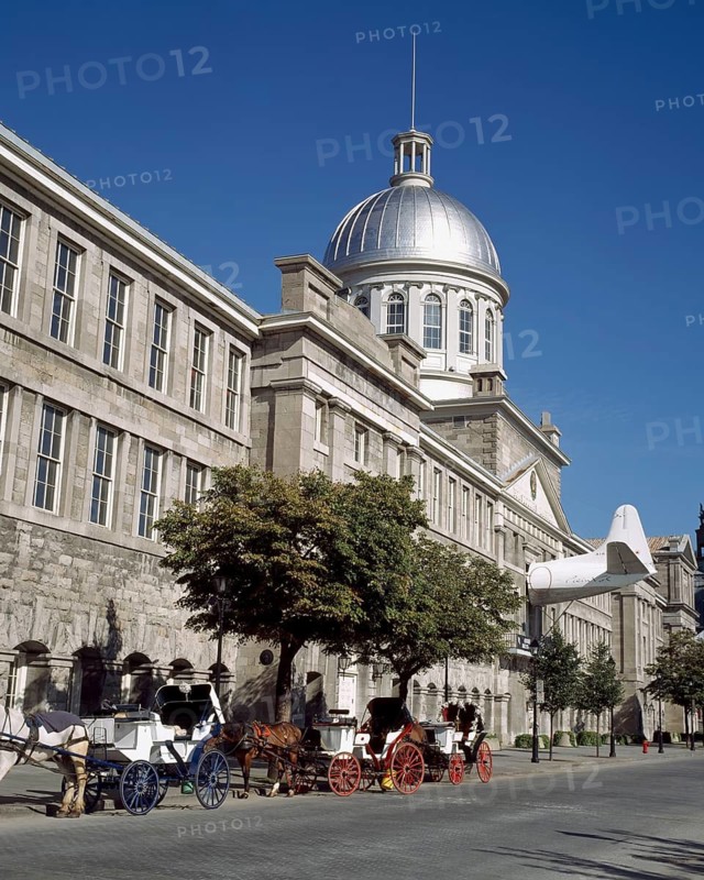 Bonsecours Market and horse-drawn carriage rides parked on Rue De la Commune street in summer, Old Montreal, Quebec, Canada