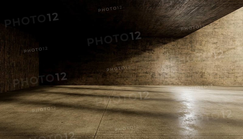 An abstract view of an empty concrete room with textured walls and floor, illuminated by dramatic light and shadows, creating a moody, minimalist atmosphere suitable for backgrounds