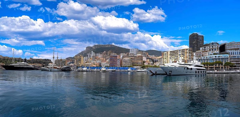 France, French Riviera, Monte Carlo view from marina with luxury yachts and cars in Monaco bay