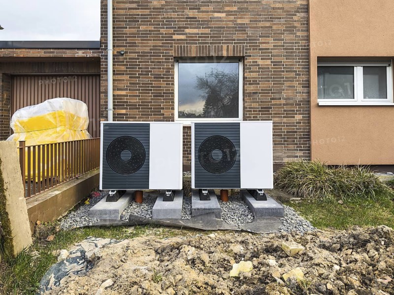2 heat pumps are installed on an apartment block in a front garden, Hilden, Germany