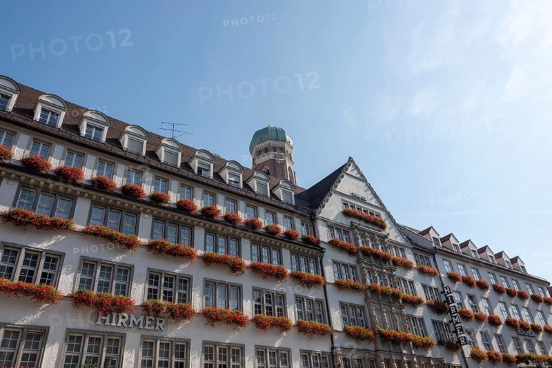Red flowers bloom in flower boxes on the facade of the Hirmer department stores', Munich, Bavaria, Germany