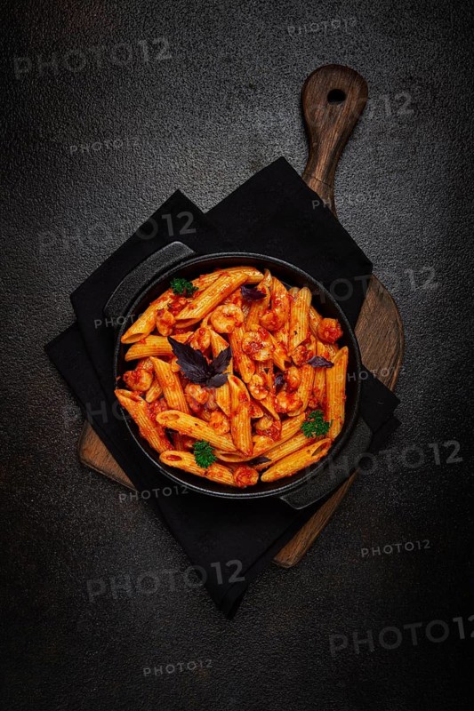 Penne pasta, with shrimp in tomato sauce, close-up, no people