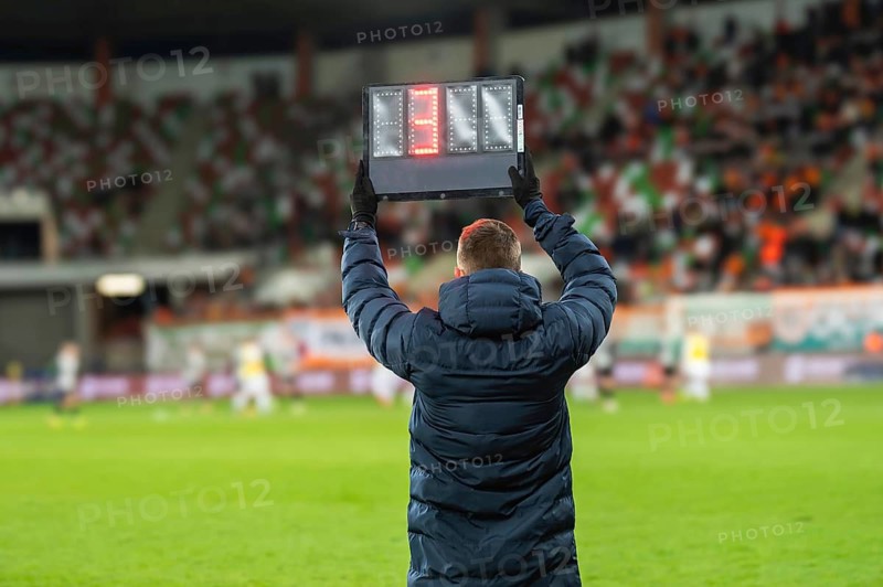 Technical referee shows added time during football match. seven, black