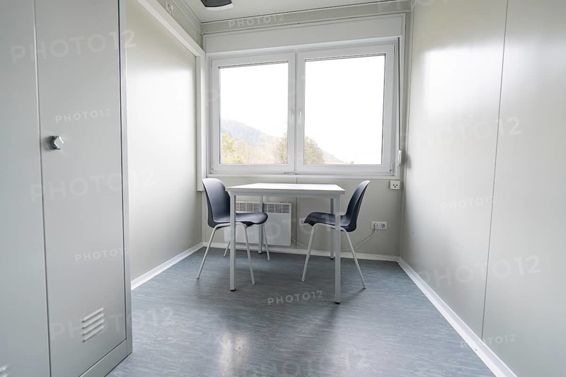 Bright room with table and two chairs, modern and minimalist design, refugee accommodation Beermiß, Calmbach, Black Forest, Germany