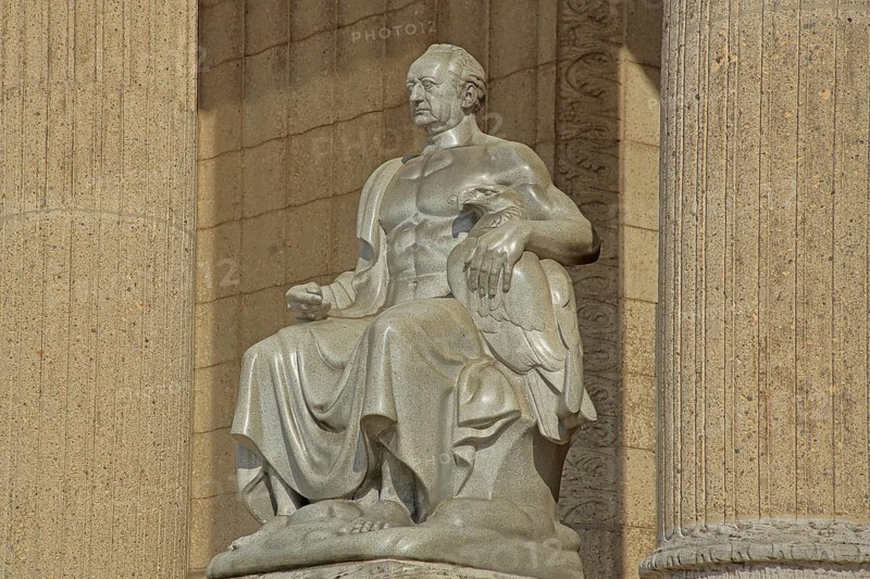 Johann Wolfgang von Goethe sitting on a throne, stone sculpture, monument, ruler, exalted, victor, triumphant, columns with fluting, Landesmuseum, city centre, Wiesbaden, Taunus, Hesse, Germany