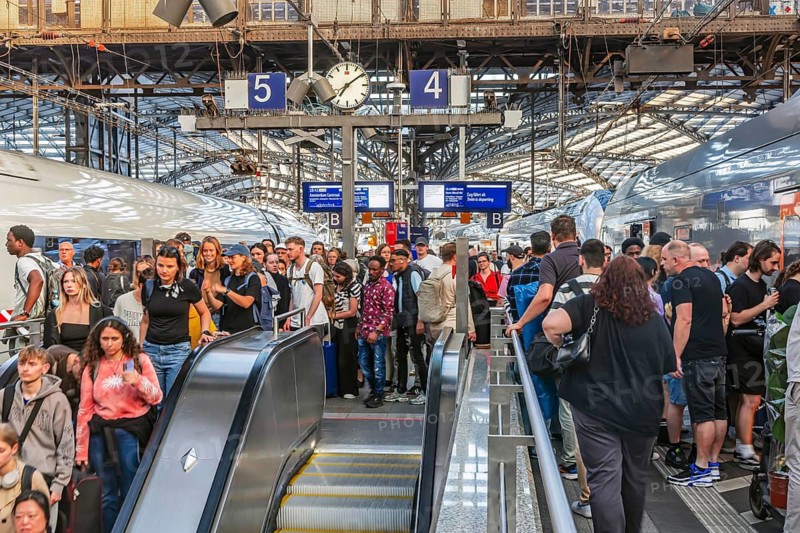 Cologne Central Station. Stairs to the platforms. Travellers waiting for their train on the platform. Crowd with motion blur. Cologne, North Rhine-Westphalia, Germany