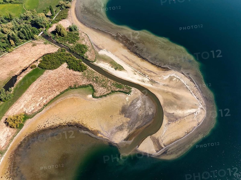 Aerial view of the mouth of the Stockacher Aach at low water, which flows into Lake Überlingen. The sedimentation of the suspended matter and sediment carried by the tributary is gradually silting up the shore zone near Bodman-Ludwigshafen. Lake Constance, district of Constance, Baden-Württemberg, Germany