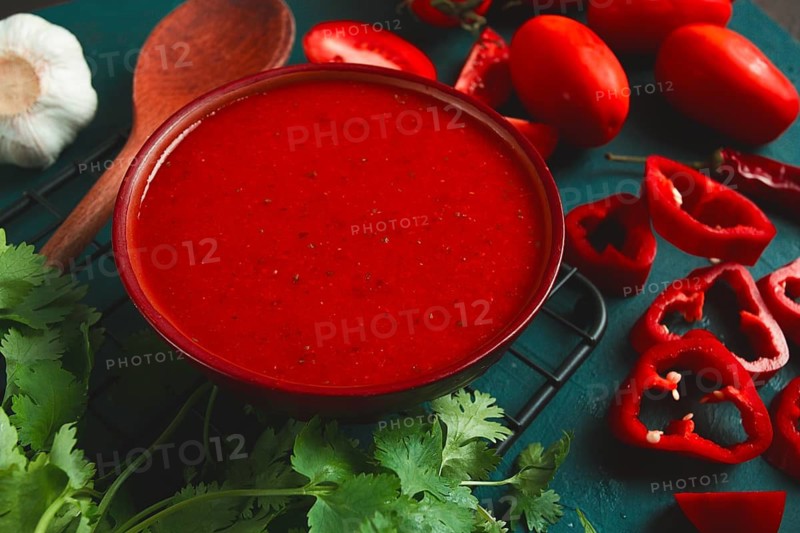 Tomato sauce, tomatoes and sweet pepper, Georgian Satsebeli sauce, with ingredients on a dark background, top view, close-up, no people