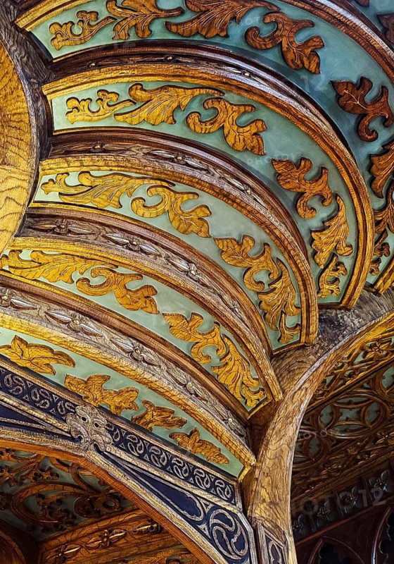 Livraria Lello, interior view of the Lello bookstore with rich decorations of the curved wooden staircase from below, Porto, Portugal